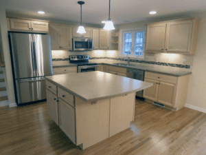 kitchen with stone counters, hardwood flooring and new appliances