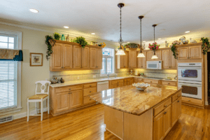 kitchen renovation with stone counters and hardwood flooring