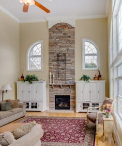 high ceiling room with fireplace interior build out