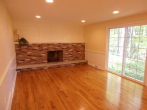 new hardwood flooring for a living room with a fireplace