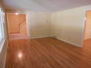 renovated living room with hardwood flooringg