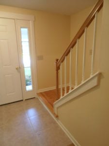 tile hallway with hardwood stairs