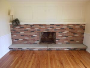 newly build fireplace and mantel with hardwood flooring