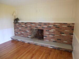 newly build fireplace and mantel with hardwood flooring