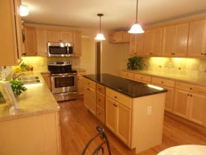 after photos - completed kitchen renovation with stone topped kitchen island and counters