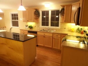 after photos - completed kitchen renovation with stone topped kitchen island and counters
