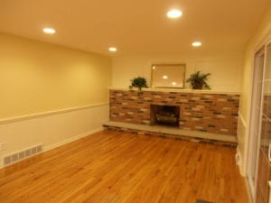 completed home renovation - fireplace room with hardwood flooring